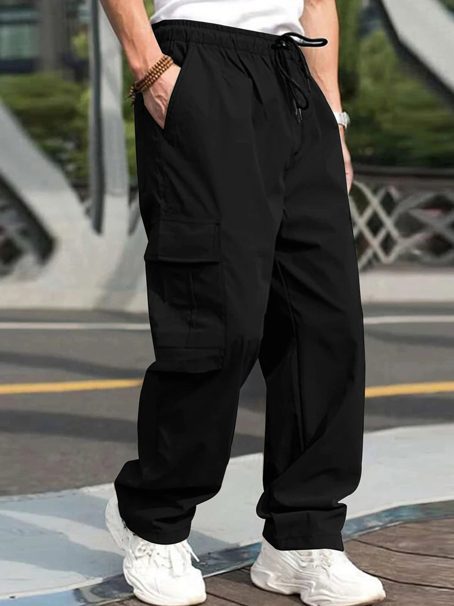 Men's loose cargo long pants from Your Outdoors n' More, featuring multiple pockets and relaxed fit, shown in dark green.