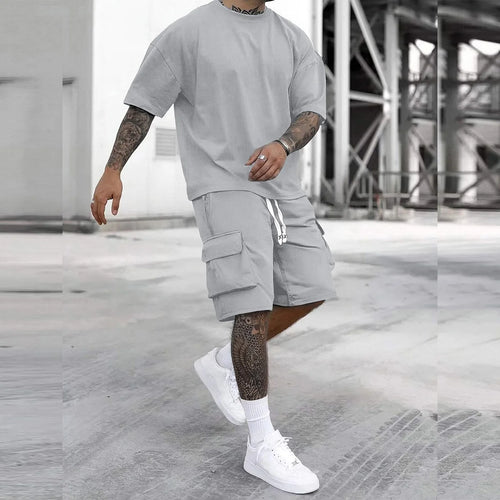 Men's multi-pocket cargo pants and short sleeve T-shirt set by Your Outdoors n' More, shown in a relaxed outdoor setting